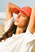 Woman wearing a red cap and white shirt with on the beach