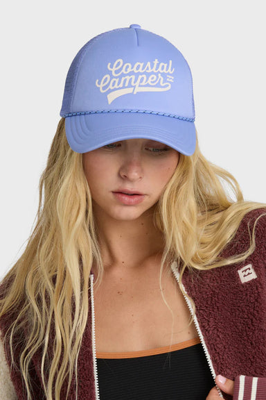 Person wearing a blue cap with 'Coastal Camper' text and a maroon jacket with a logo.