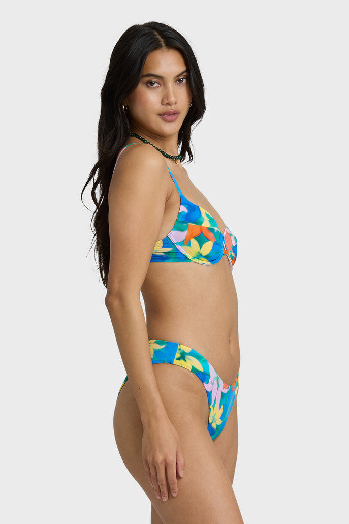 Woman wearing a colorful bikini set on a white background