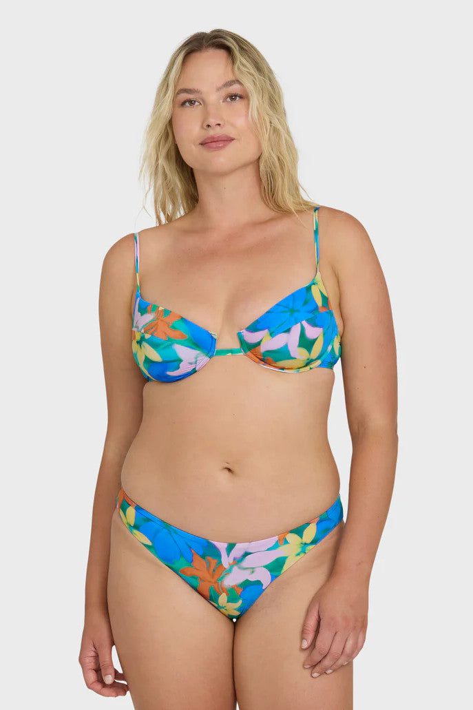 Woman wearing a colorful bikini set on a white background