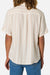 Person wearing a beige striped shirt and blue jeans on a white background