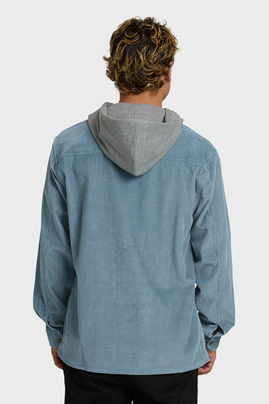 Person wearing a blue corduroy shirt with a gray hood on a white background