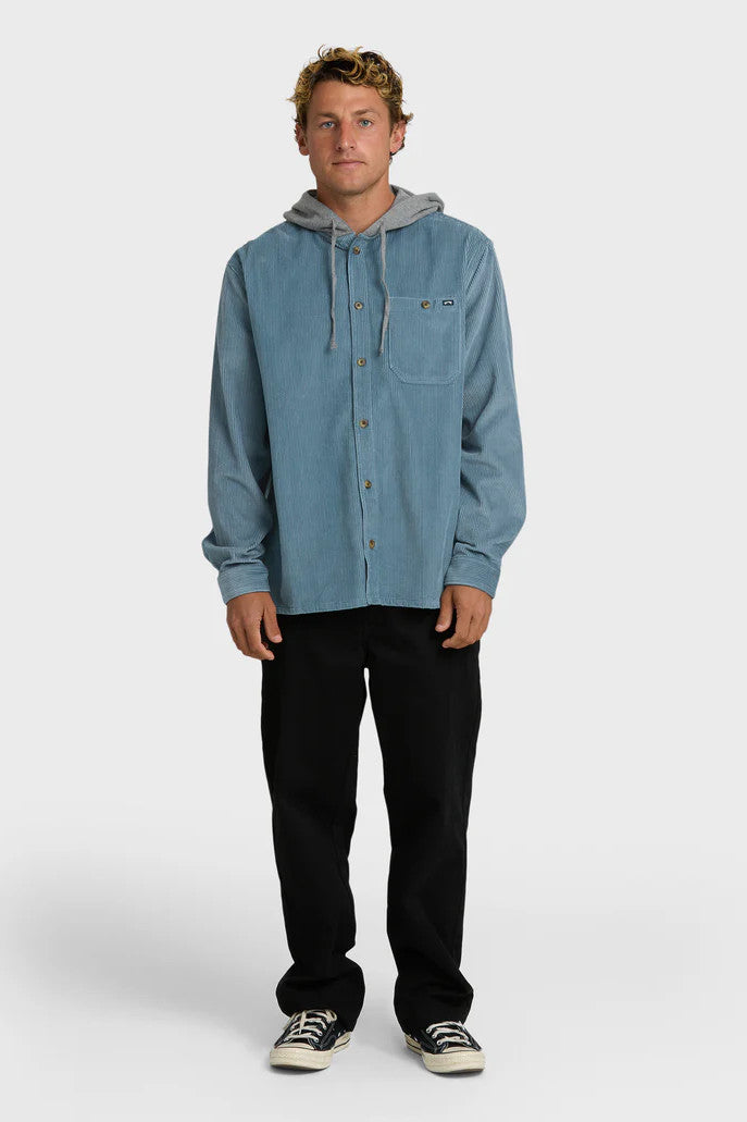 Man wearing a blue corduroy shirt with a hood on a white background