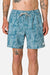 Person wearing blue floral-patterned shorts on a white background