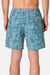 Person wearing blue floral-patterned shorts on a plain background