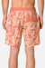 Person wearing coral floral-patterned shorts on a plain background
