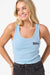 Woman wearing a light blue tank top with a logo on a white background