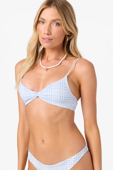 Woman wearing a light blue and white plaid bikini on a white background