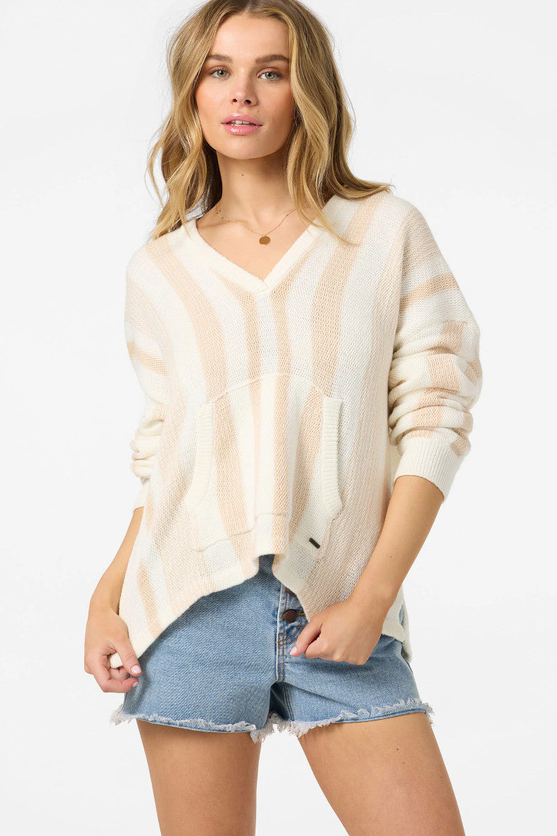 Woman wearing a light-colored cardigan over a denim shirt on a white background