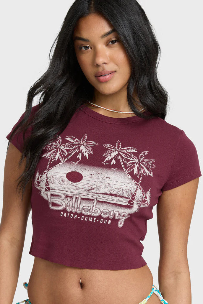 Woman wearing a maroon graphic t-shirt on a white background