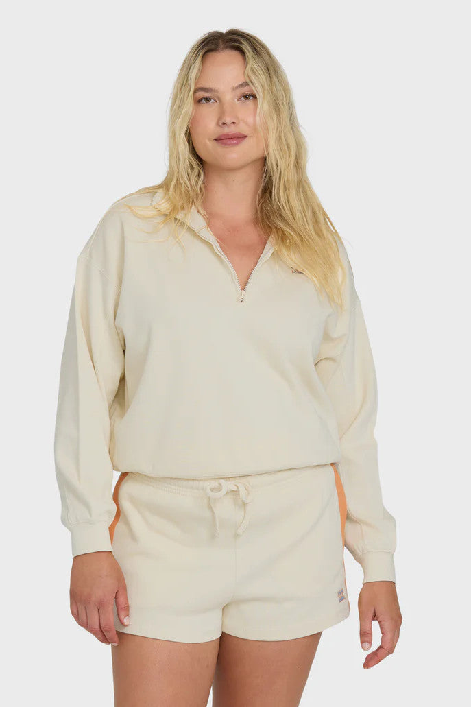 Woman wearing a beige lounge set on a white background