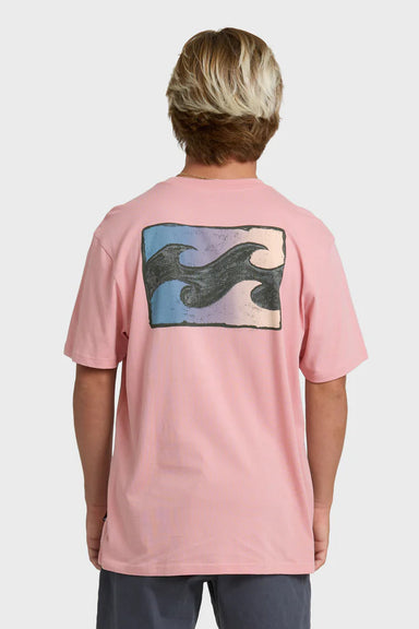 Man wearing a pink t-shirt with a wave design on the back against a white background