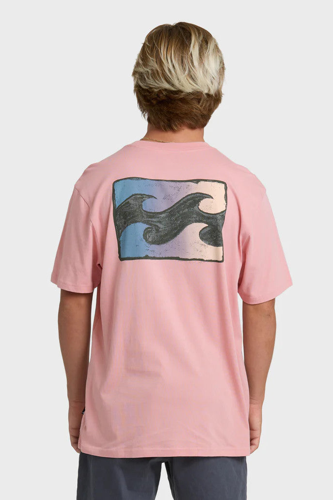 Man wearing a pink t-shirt with a wave design on the back against a white background