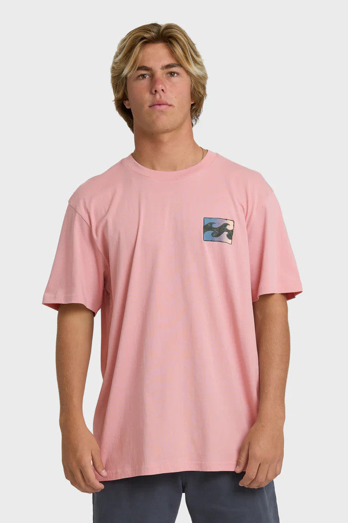 Man wearing a pink t-shirt with a wave design on the chest against a white background