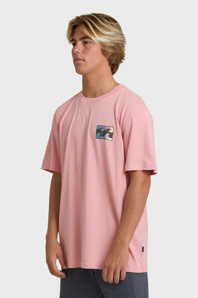 Man wearing a pink t-shirt with a wave design on the chest against a white background