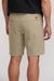 Person wearing beige shorts on a plain background