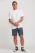 Man wearing a white t-shirt and navy shorts on a plain background