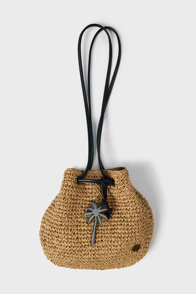 Woven bag with a black strap and palm tree charm on a light gray background