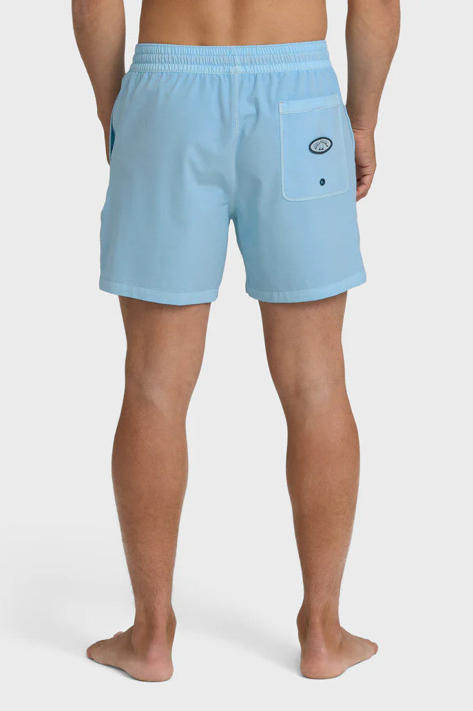 Back view of a man wearing light blue swim shorts with an elastic waist and back pocket with branding patch on a white background
