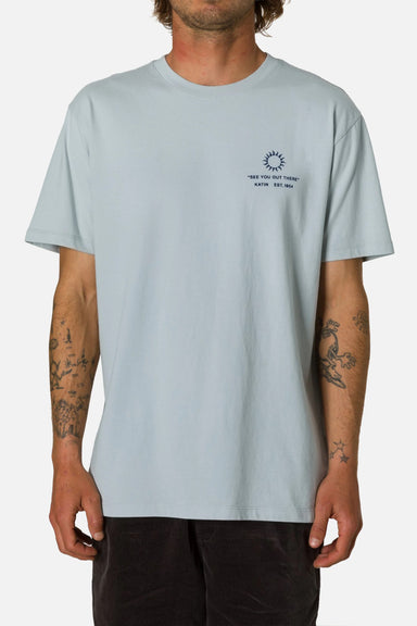 Light blue t-shirt with a small graphic on a plain background
