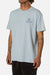 Light blue t-shirt with a small graphic and text worn by a person on a white background