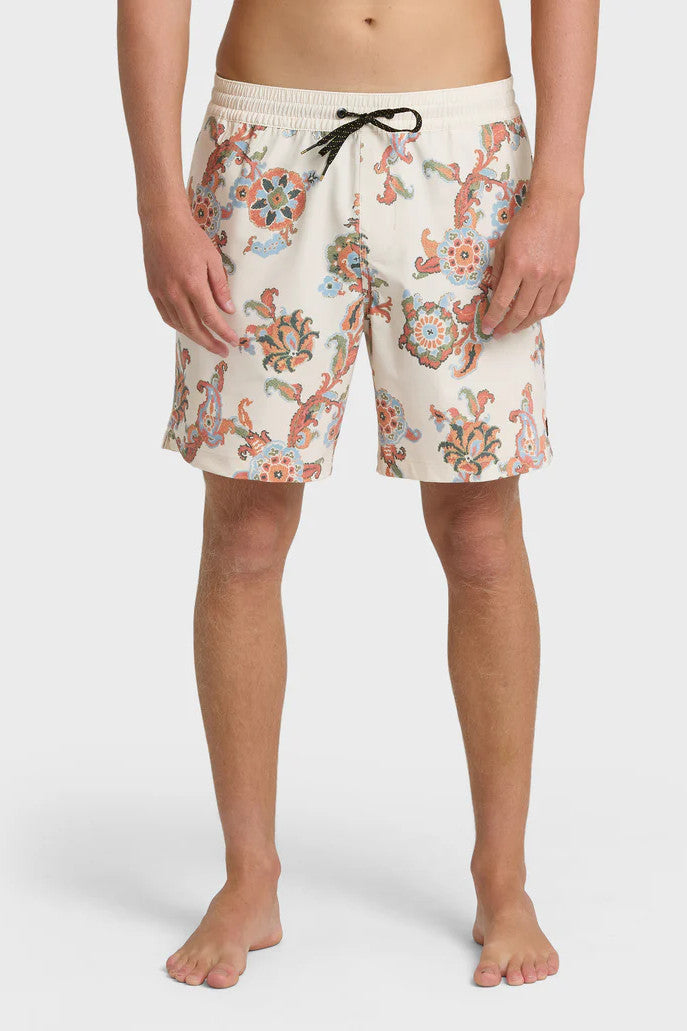 A man wearing cream boardshorts with a floral paisley pattern, elastic waist and drawstring on a white background.