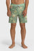Man wearing a pair of boardshorts that are primarily green with a green, coral, and yellow palm tree and starfish design on a white background.