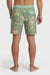 Back view of a man wearing a pair of boardshorts that are primarily green with a green, coral, and yellow palm tree and starfish design on a white background.