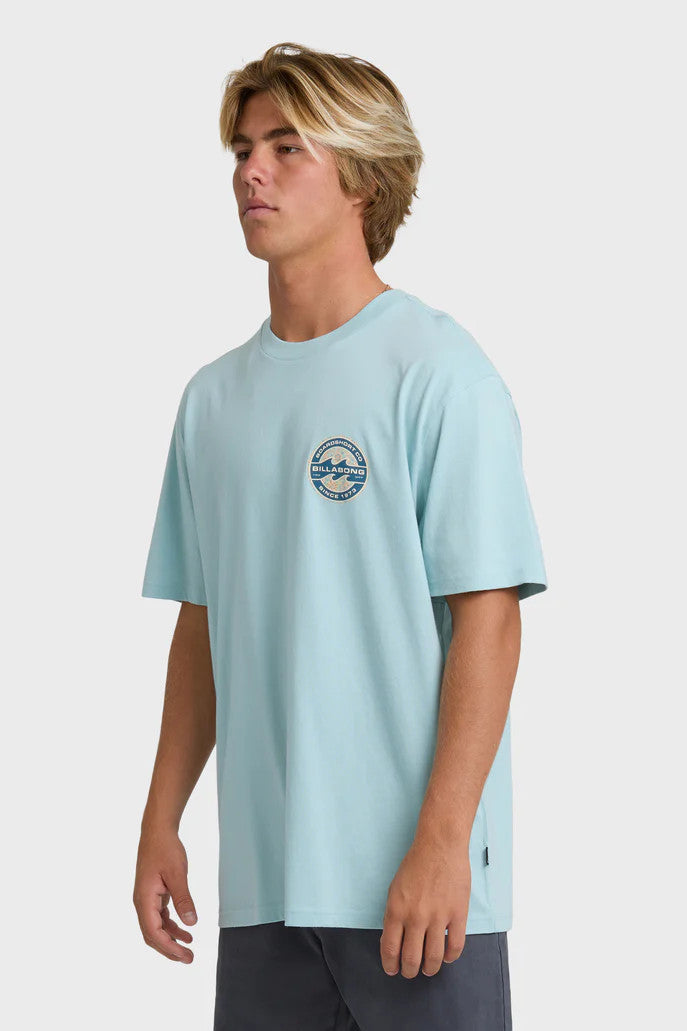 Person wearing a light blue t-shirt with a graphic design on a white background