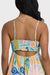 Colorful patterned dress with cutout back design on a plain background