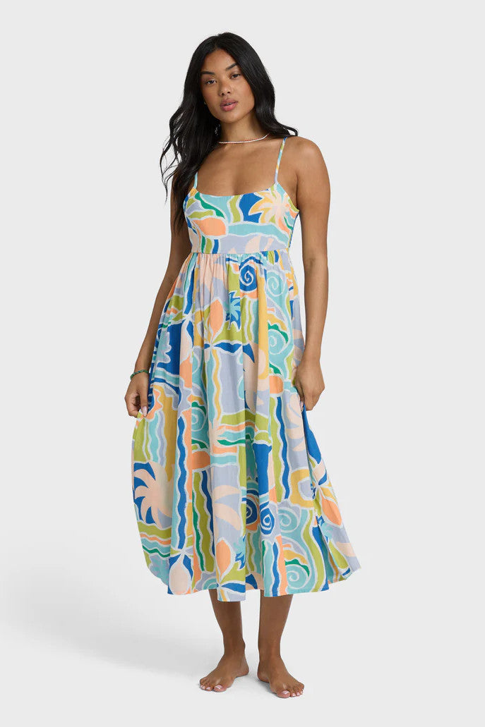 Woman wearing a colorful patterned dress on a white background