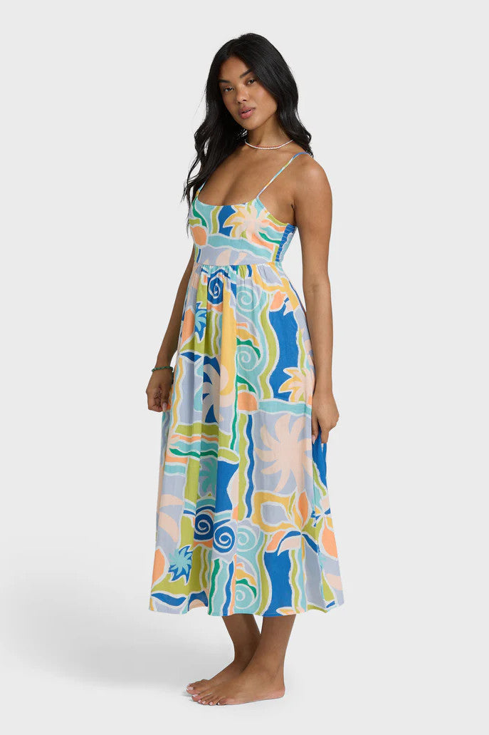 Woman wearing a colorful patterned dress on a white background