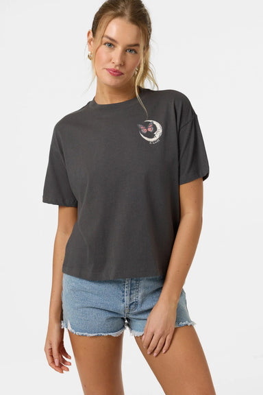 Woman wearing a dark gray t-shirt with a small graphic on a white background