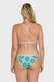 Back view of a woman wearing a blue bikini with floral patterns on a white background