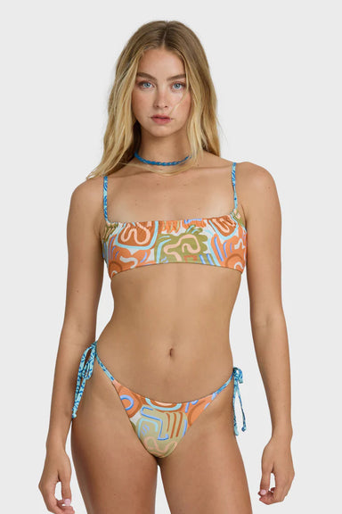 Woman wearing a colorful bikini set on a white background