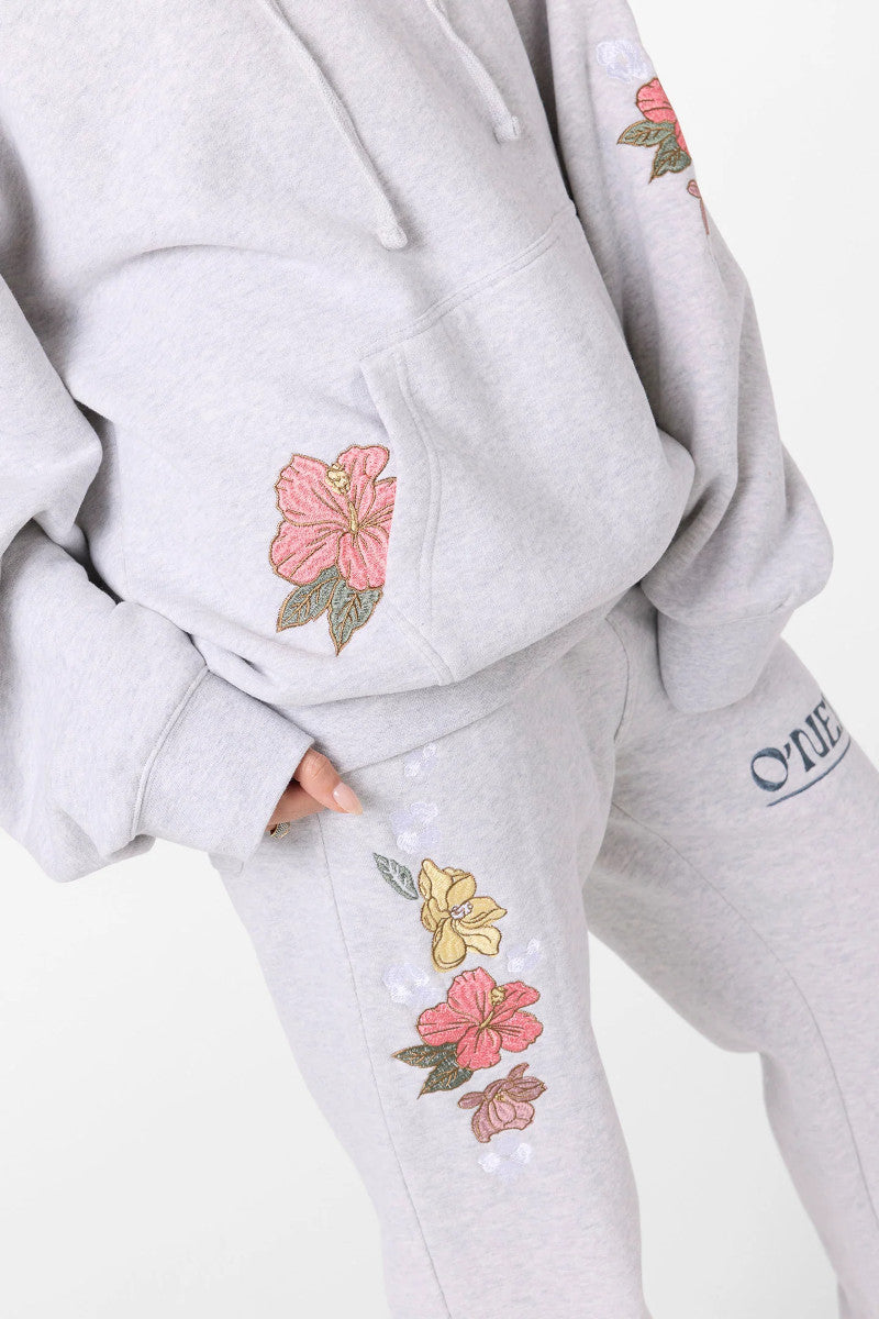Gray sweatshirt and pants with floral embroidery on a white background