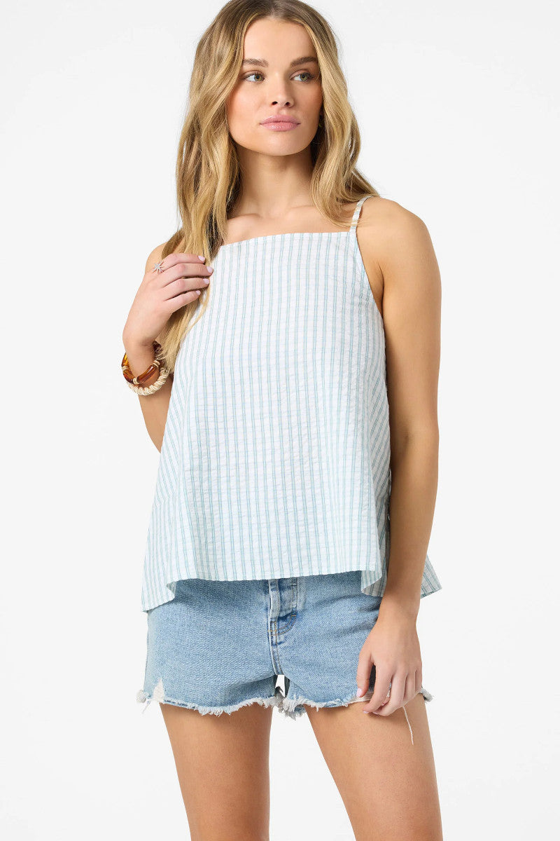 Woman wearing a light blue striped tank top and denim shorts on a white background