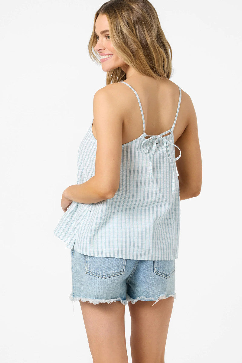 Woman wearing a light blue striped tank top and denim shorts on a white background