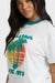 Woman wearing a Billabong t-shirt with a palm tree design on a white background