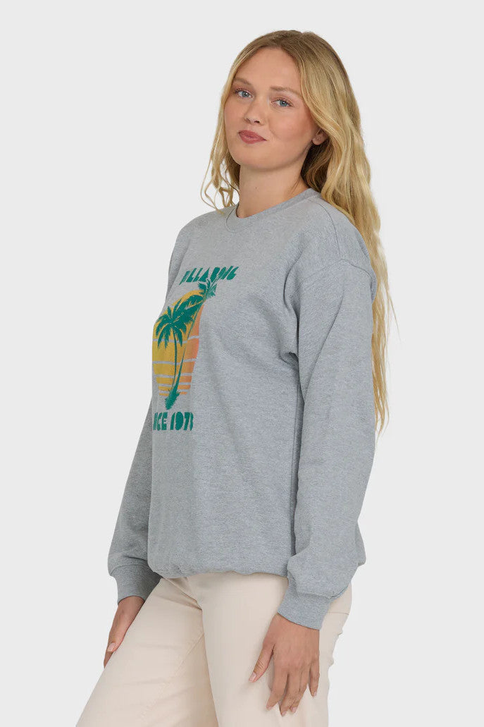 Woman wearing a gray sweatshirt with a palm tree design and 'Billabong Since 1973' text on a white background