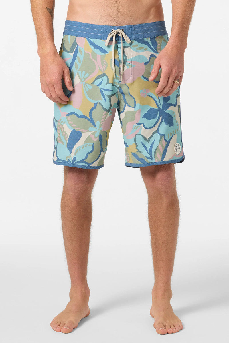 Multicolored patterned swim shorts worn by a person on a white background