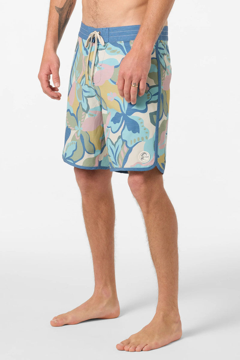 Person wearing colorful floral-patterned shorts on a white background