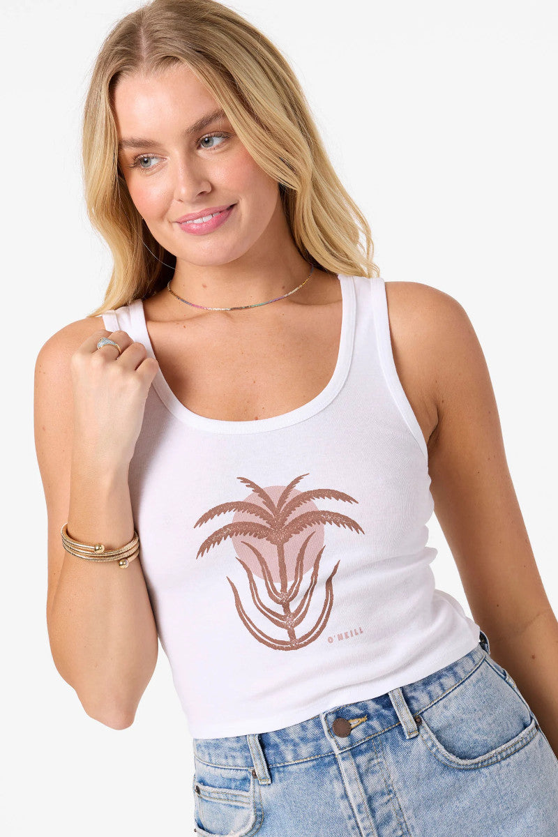 Woman wearing a white tank top with a palm tree design on a plain background