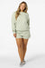 Woman wearing a light green sweatshirt and shorts set on a white background