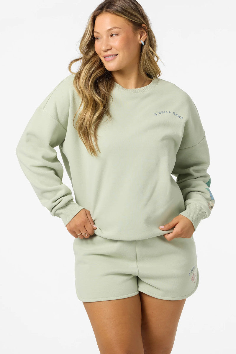 Woman wearing a light green sweatshirt and shorts set on a white background