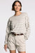 Woman wearing a striped sweater and beige shorts on a white background