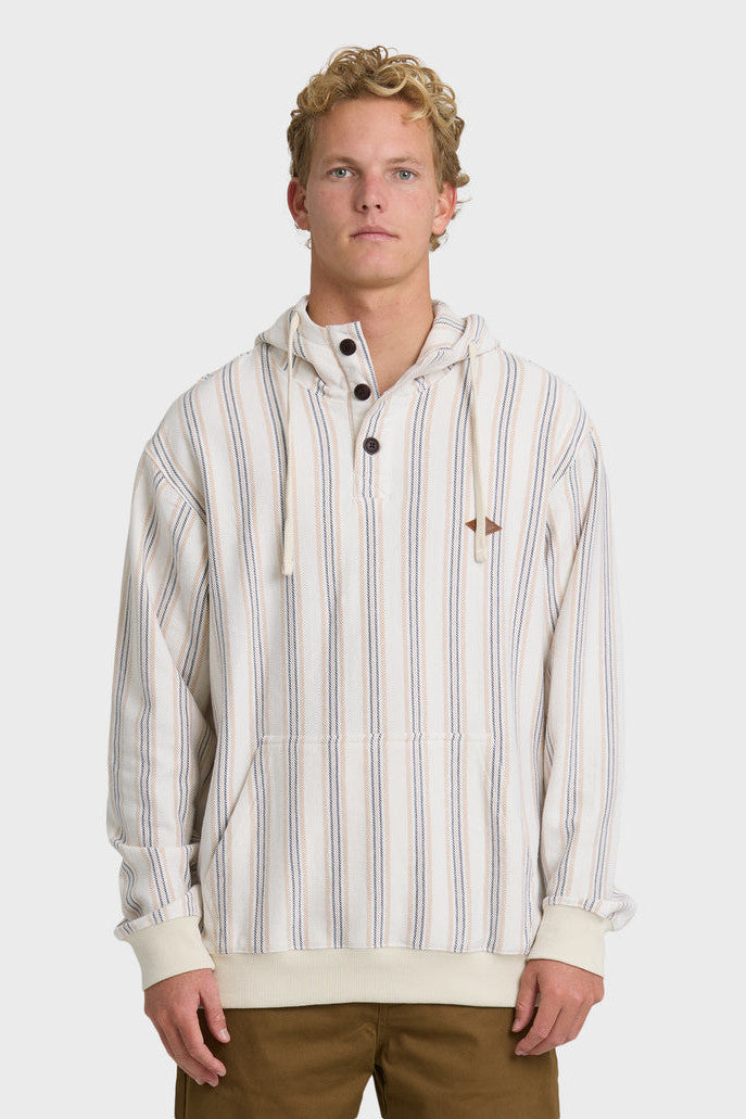 A man wearing a cream, blue, and light orange vertical striped pullover hoodie with a kangaroo pocket and button collar.