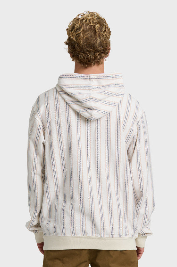 Back view of a man wearing a cream, blue, and light orange vertical striped pullover hoodie.