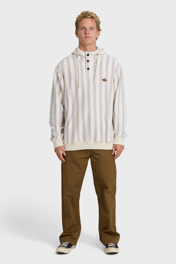A man wearing a cream, blue, and light orange vertical striped pullover hoodie with a kangaroo pocket and button collar.
