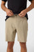 Person wearing beige shorts and a black shirt on a white background